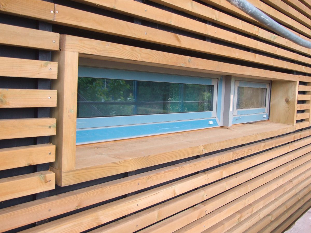 Open-joint timber facade with a window