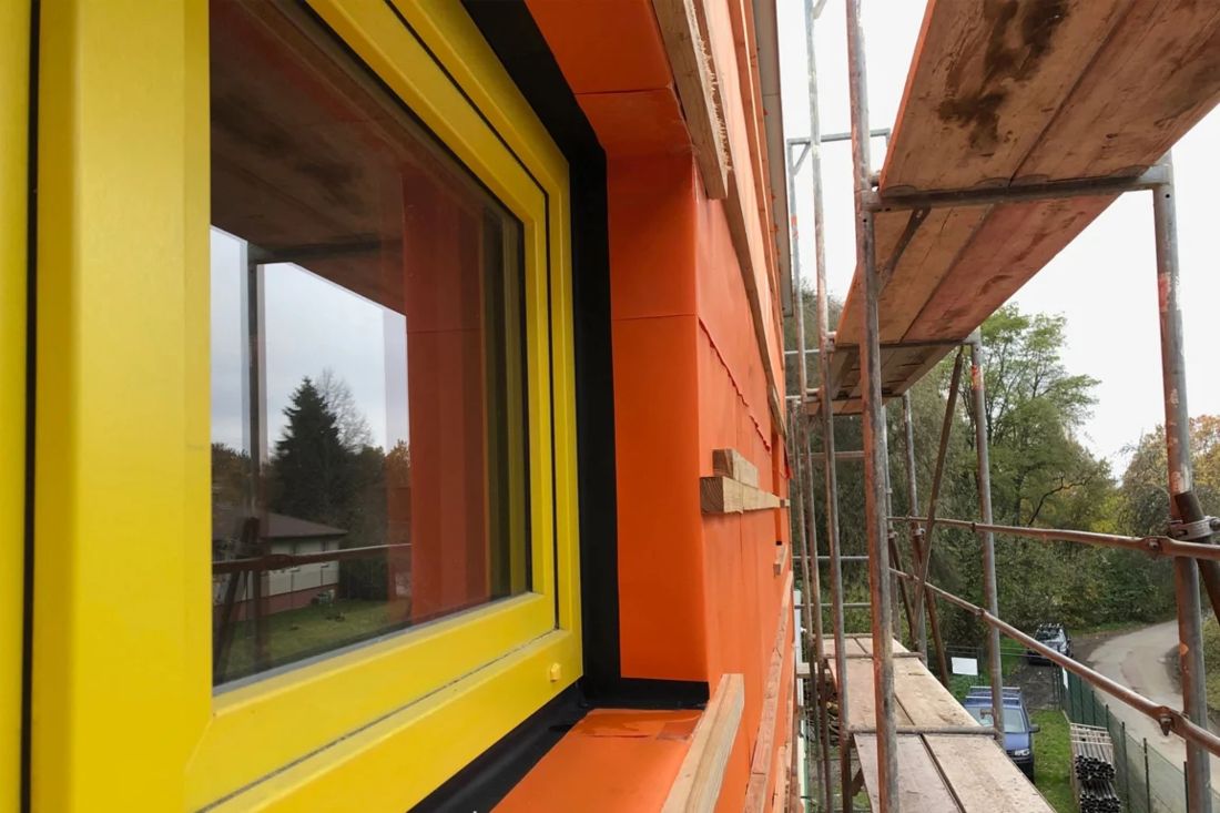 COLOR PLUS behind an open timber facade